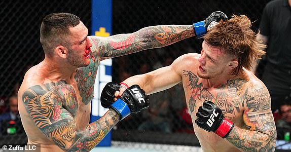 SYDNEY, AUSTRALIA - FEBRUARY 09: (L-R) Rodolfo Bellato of Brazil punches Jimmy Crute of Australia in a light heavyweight fight during the UFC 312 event at Qudos Bank Arena on February 09, 2025 in Sydney, Australia.  (Photo by Jeff Bottari/Zuffa LLC)