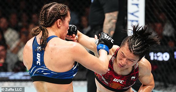 SYDNEY, AUSTRALIA - FEBRUARY 09: (R-L) Zhang Weili of China punches Tatiana Suarez in the UFC strawweight championship fight during the UFC 312 event at Qudos Bank Arena on February 09, 2025 in Sydney, Australia.  (Photo by Jeff Bottari/Zuffa LLC)