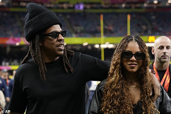Jay-Z and his daughter Blue Ivy Carter, right, are seen on the sidelines before the NFL Super Bowl 59 football game between the Kansas City Chiefs and the Philadelphia Eagles, Sunday, Feb. 9, 2025, in New Orleans. (AP Photo/Doug Benc)