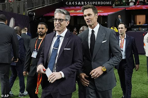 Tom Brady, right, arrives prior to the NFL Super Bowl 59 football game between the Kansas City Chiefs and the Philadelphia Eagles, Sunday, Feb. 9, 2025, in New Orleans. (AP Photo/Frank Franklin II)