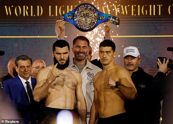 Boxing - Light Heavy Championship - Artur Beterbiev v Dmitrii Bivol - Weigh-In - Boulevard City, Riyadh, Saudi Arabia - February 21, 2025 Artur Beterbiev and Dmitrii Bivol during the Weigh-In as promoter Eddie Hearn looks on REUTERS/Hamad I Mohammed     TPX IMAGES OF THE DAY