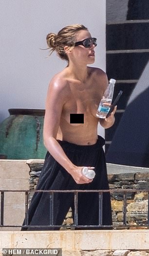 Još uvijek bez toplesa, Nader se promijenio u par crnih hlača i viđen je kako razgovara na telefonu i nosi bocu s vodom