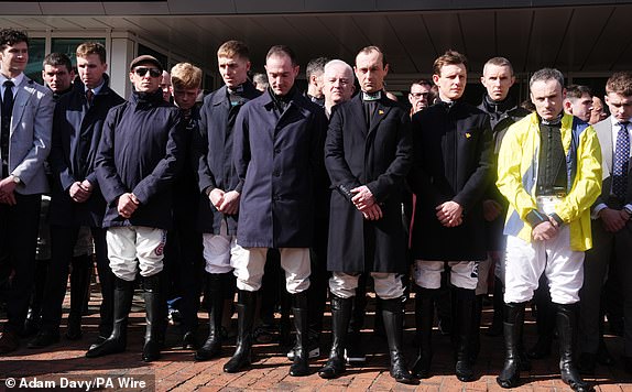Jockeys stand for a moments silence for Michael O'Sullivan on day one of the 2025 Cheltenham Festival at Cheltenham Racecourse. Picture date: Tuesday March 11, 2025. PA Photo. See PA story RACING Cheltenham. Photo credit should read: Adam Davy/PA Wire.RESTRICTIONS: Use subject to restrictions. Editorial use only, no commercial use without prior consent from rights holder.