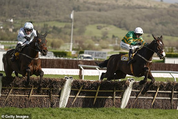 CHELTENHAM, ENGLAND - MARCH 15: Mark Walsh riding Majborough (green/gold) clear the last to win The JCB Triumph Hurdle during day four of the Cheltenham Festival 2024 at Cheltenham Racecourse on March 15, 2024 in Cheltenham, England. (Photo by Alan Crowhurst/Getty Images)