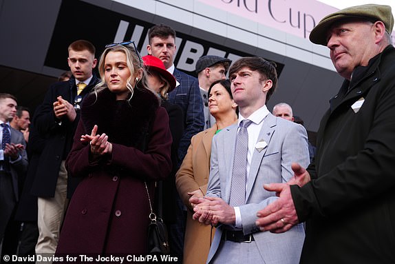 Family of Michael O'Sullivan, girlfriend Charlotte Giles and his brother Alan O'Sullivan pay their respects before the first race on day one of the 2025 Cheltenham Festival at Cheltenham Racecourse. Picture date: Tuesday March 11, 2025. PA Photo. See PA story RACING Cheltenham. Photo credit should read: David Davies for The Jockey Club/PA Wire.RESTRICTIONS: Editorial Use only, commercial use is subject to prior permission from The Jockey Club/Cheltenham Racecourse.
