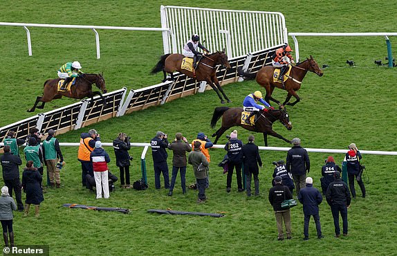 Horse Racing - Cheltenham Festival - Cheltenham Racecourse, Cheltenham, Britain - March 13, 2025 Sixandahalf ridden by Keith Donoghue and Air Of Entitlement ridden by Rachael Blackmore in action during the 13:20 Ryanair Mares' Novices' Hurdle REUTERS/Peter Cziborra