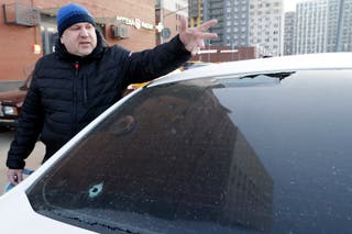 A damaged car is seen on the grounds of a residential complex following a drone attack in the village of Sapronovo in the Moscow region on 11 March 2025