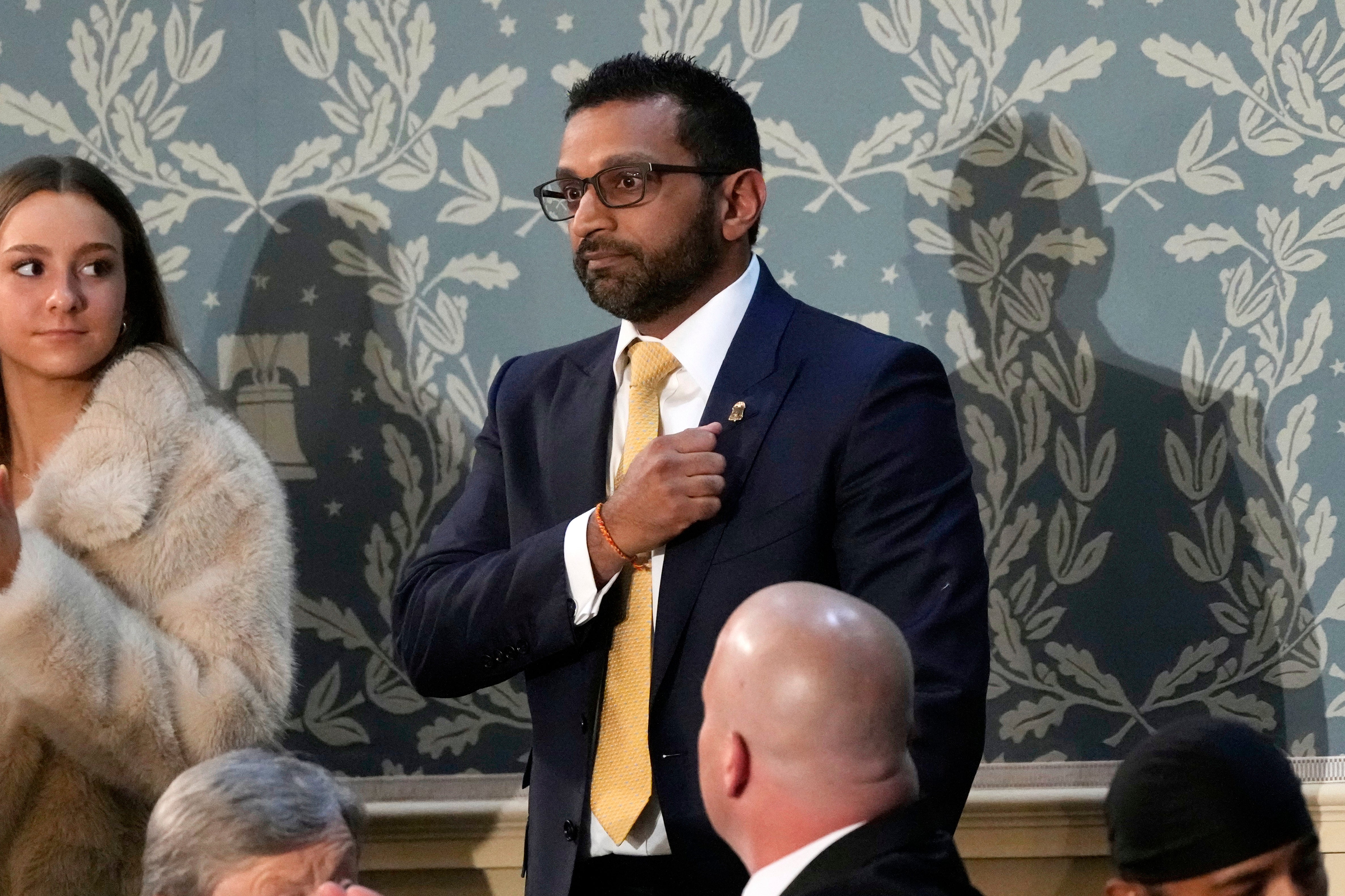 FBI Director Kash Patel stands after Trump acknowledges him