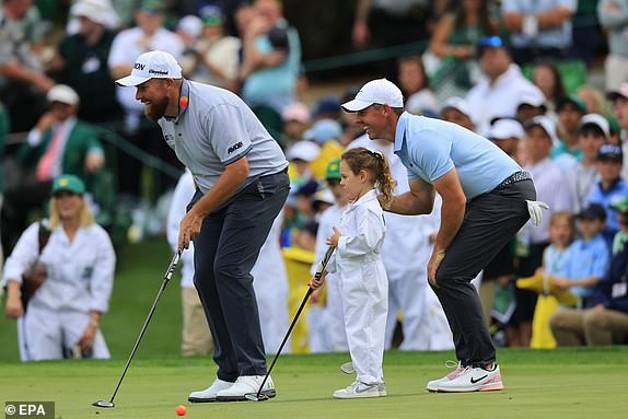 epa12021679 Rory McIlroy of Northern Ireland (R) watches his daughter Poppy's (C) ball as it rolls towards the hole with Shane Lowry of Ireland (L) on the ninth green during the Par 3 Contest during the 2025 Masters Tournament at the Augusta National Golf Club in Augusta, Georgia, USA, 09 April 2025.  EPA/CJ GUNTHER