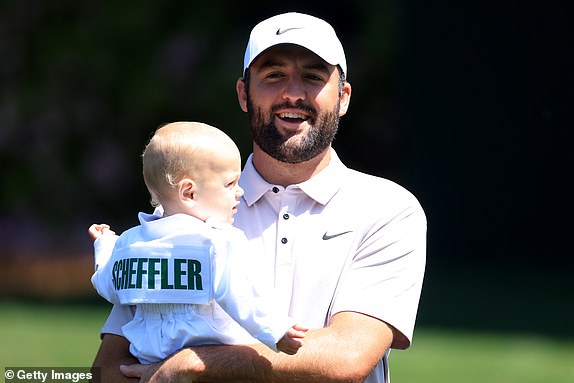AUGUSTA, GEORGIA - APRIL 9:  Scottie Scheffler of the United States reacts with his son Bennett during the Par Three Contest prior to the 2025 Masters Tournament at Augusta National Golf Club on April 9, 2025 in Augusta, Georgia. (Photo by David Cannon/Getty Images)