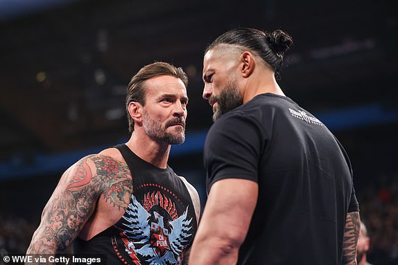 ROSEMONT, ILLINOIS - APRIL 4: CM Punk and Roman Reigns face off during SmackDown at Allstate Arena on April 4, 2025 in Rosemont, Illinois.  (Photo by Eric Johnson/WWE via Getty Images)