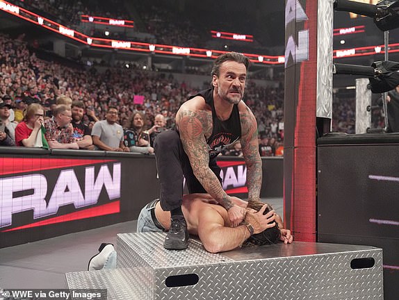 MINNEAPOLIS, MINNESOTA - APRIL 7: CM Punk attacks Seth Rollins during Monday Night RAW at Target Center on April 7, 2025 in Minneapolis, Minnesota.  (Photo by Craig Melvin/WWE via Getty Images)
