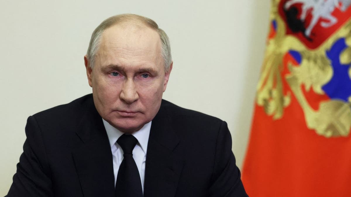 Putin frowning closeup shot with Russia flag