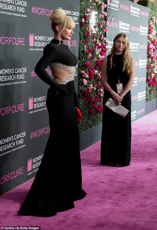 Pristupila je haljini za ispuštanje čeljusti s zasljepljujućim dijamantnim naušnicama i vatrogasnom motorom crvenom torbom