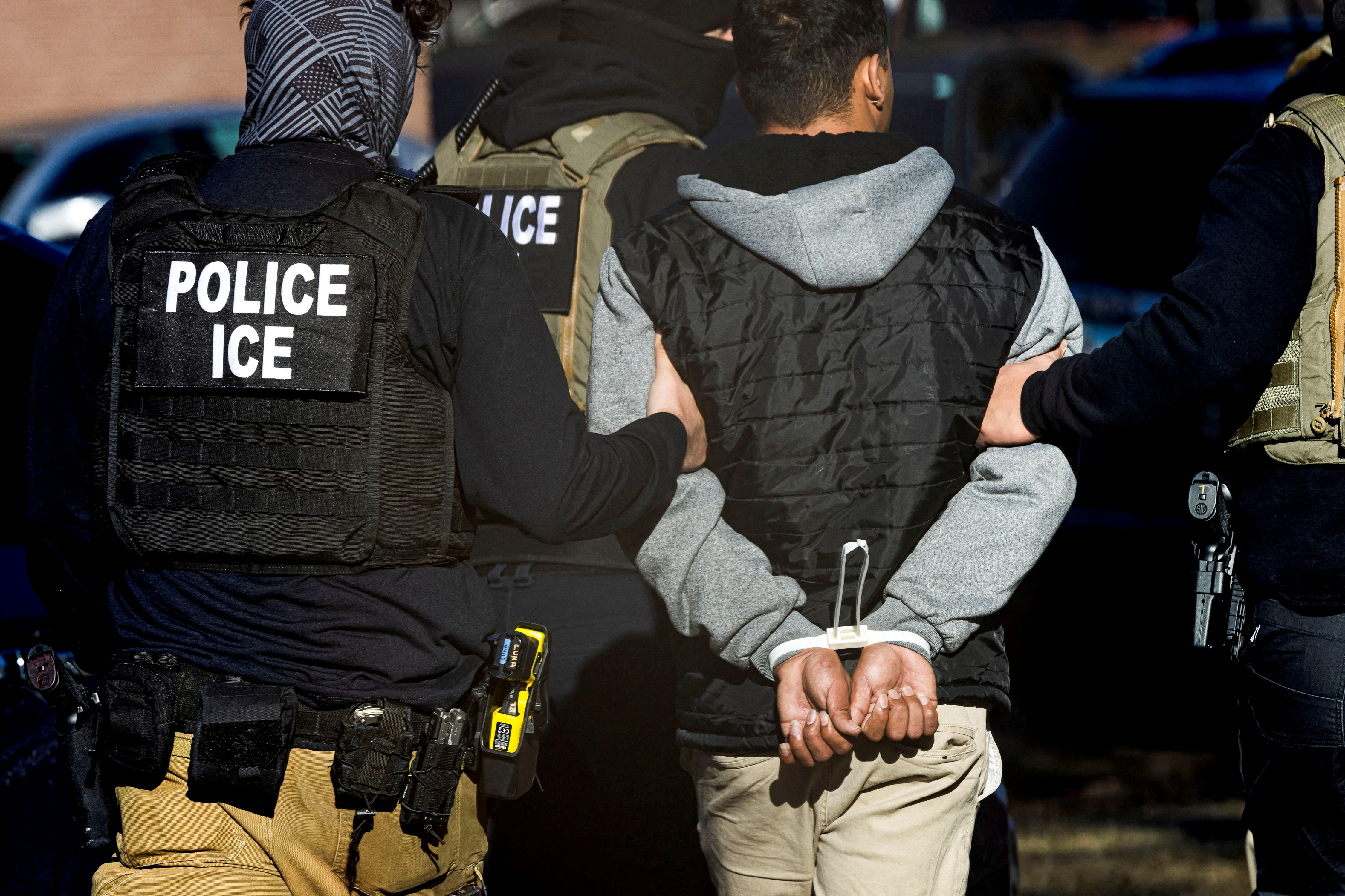 Immigration and Customs Enforcement agents detain a man after conducting a raid at the Cedar Run apartment complex in Denver, Colorado, U.S., February 5, 2025. REUTERS/Kevin Mohatt/File Photo