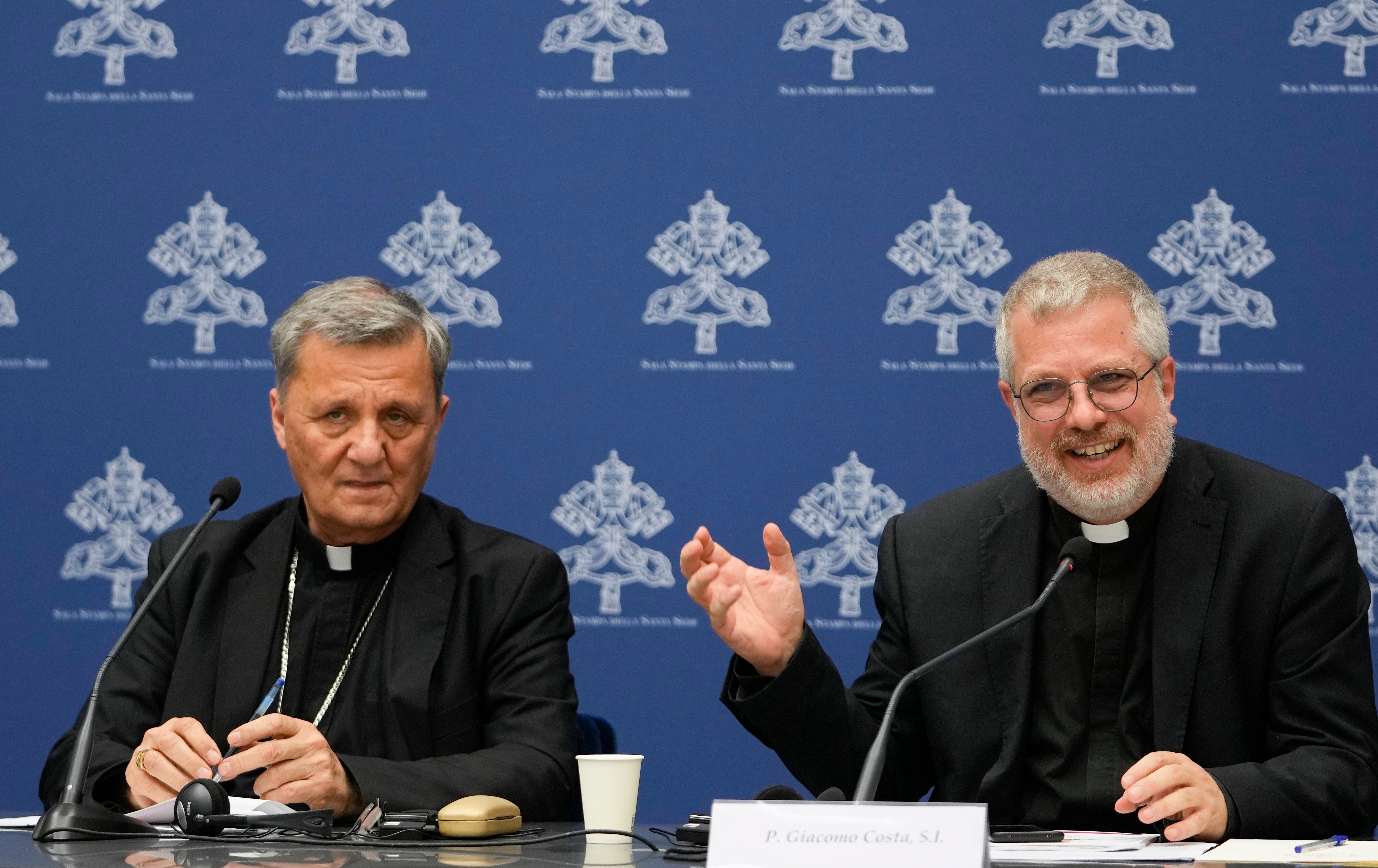 Cardinal Mario Grech (left) at a press conference