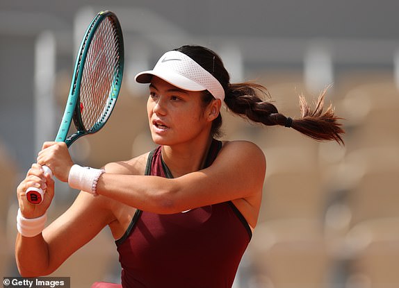 PARIS, FRANCE - MAY 28: Emma Raducanu of Great Britain plays a backhand against Iga Swiatek of Poland during the Women's Singles Second Round match on Day Four of the 2025 French Open at Roland Garros on May 28, 2025 in Paris, France. (Photo by Adam Pretty/Getty Images)