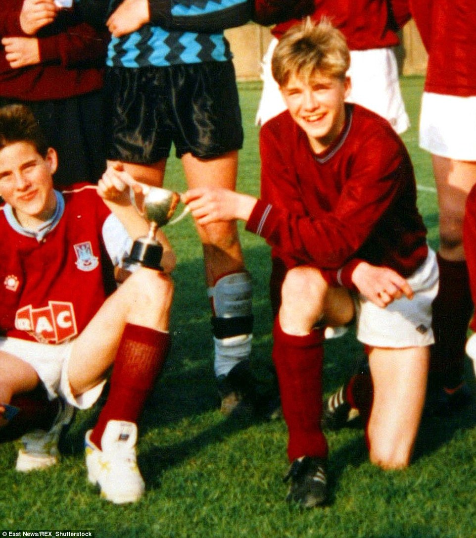 Beckham celebrates after winning a trophy with Chingford High in 1990. The honours would keep on coming for the player following his move to Manchester the following year