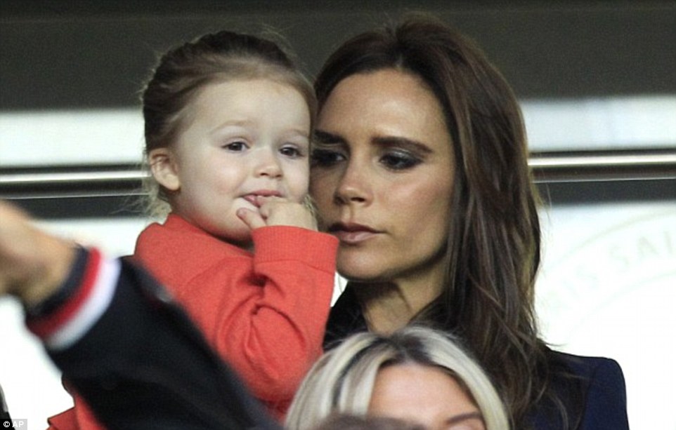 Victoria held Harper as they cheered David on during his final game in Paris from the stands