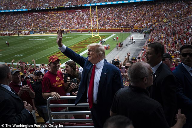 Trump enjoys being given a chance to show off; he is pictured at a college football game in 2023