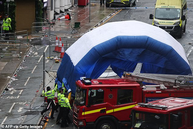 Police officers cover area with an inflatable tent to preserve evidence