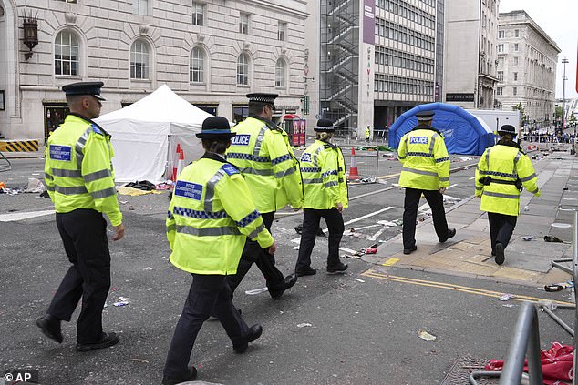Police are pictured this morning after 47 people were injured when a car ploughed into the crowd