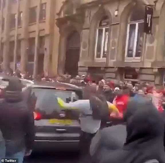 In footage shared widely on social media, one spectator was seen kicking and punching the car which then reversed into him
