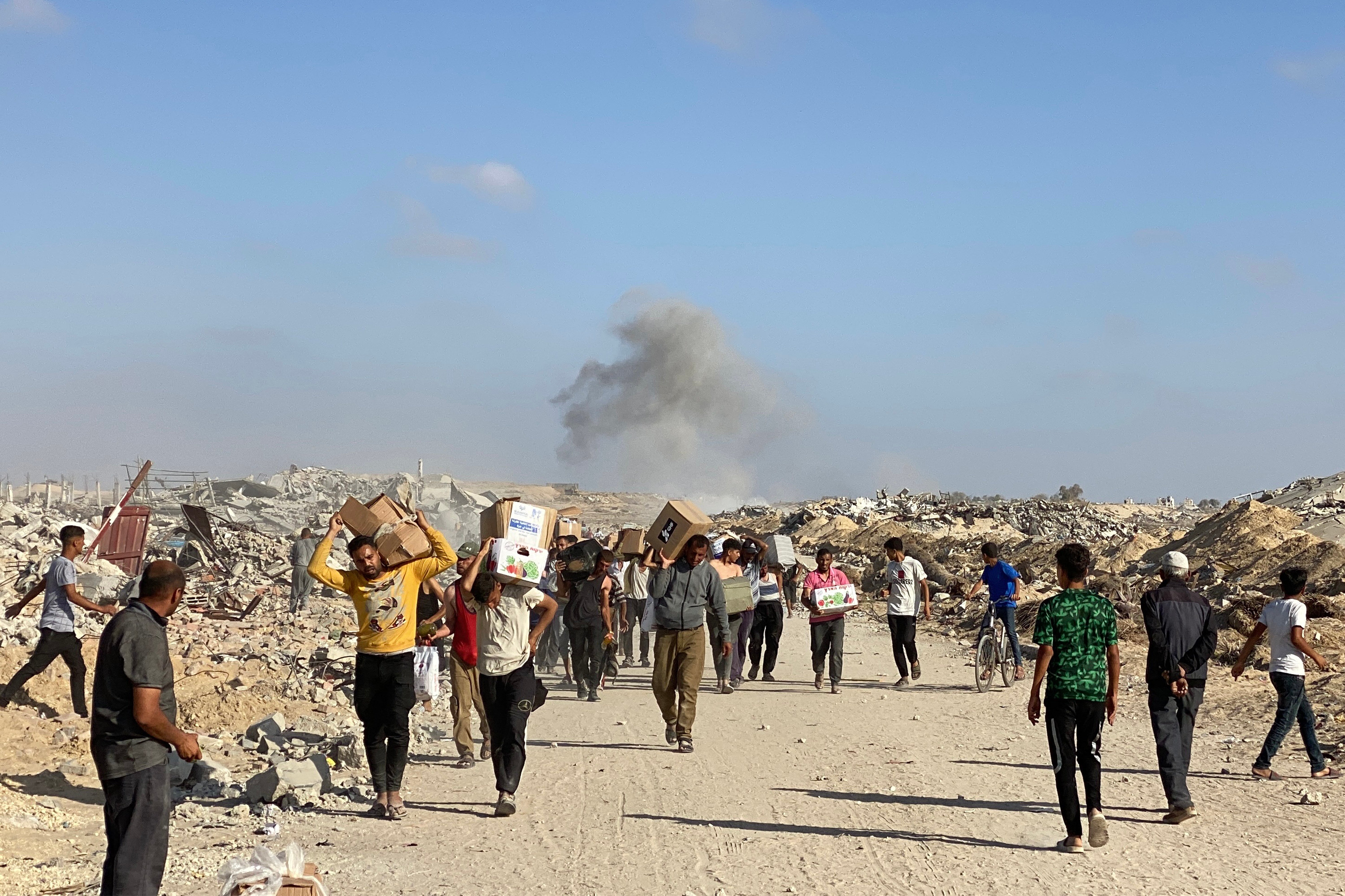 Prognani Palestinci primaju pakete hrane od zaklade podržane u SAD-u koji je obvezao distribuciju humanitarne pomoći u zapadnoj Rafah u južnoj Gazi Strip 27. svibnja 2025.