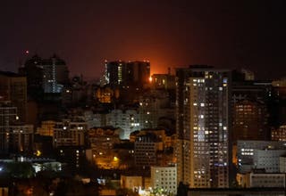An explosion of a drone is seen in the sky over the city during a Russian drone strike in Kyiv