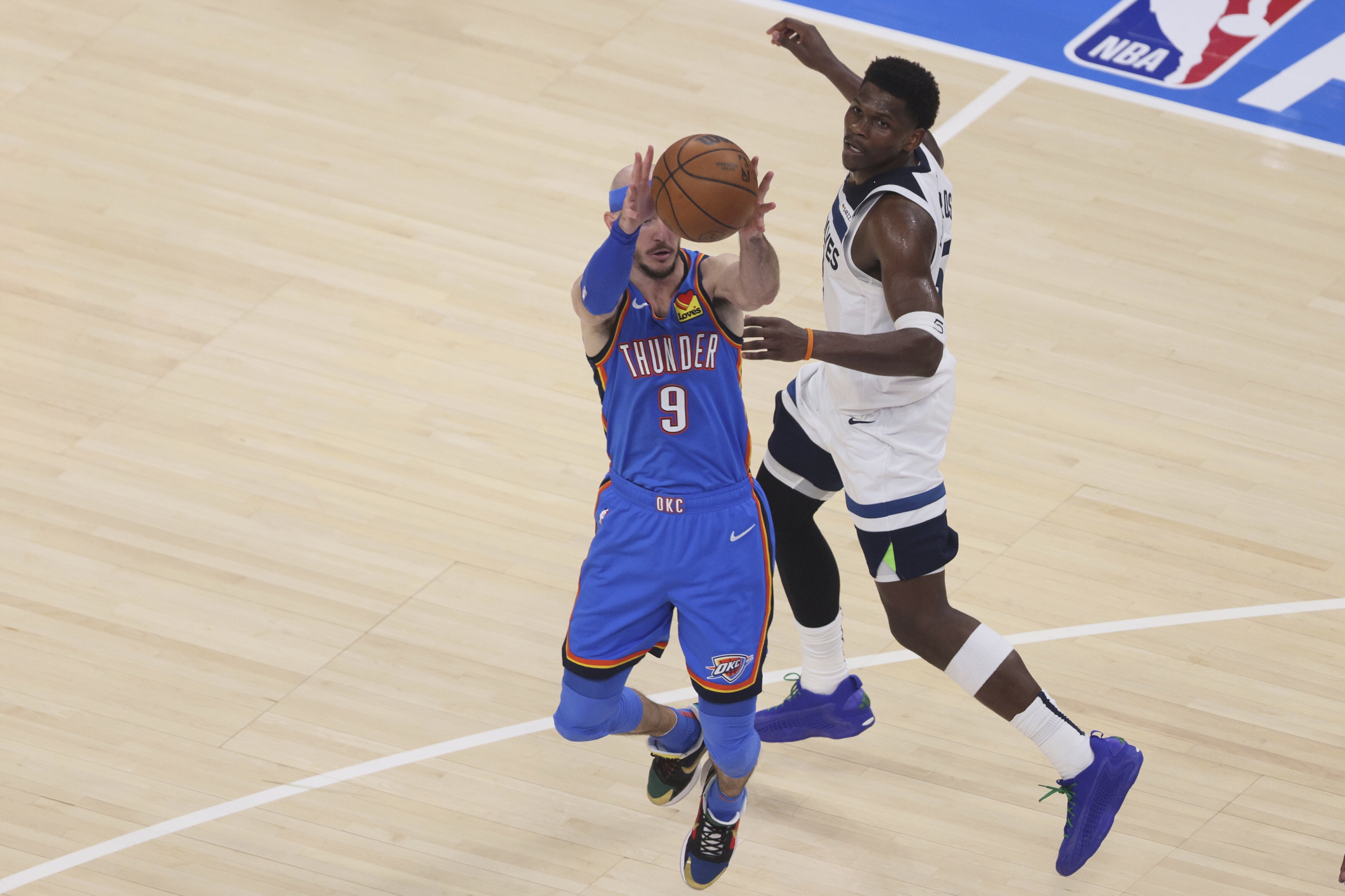 Oklahoma City Thunder čuvar Alex Caruso (9) ukrade propusnicu namijenjenu Minnesota Timberwolves čuvara Anthonyja Edwardsa (5) tijekom prve polovice utakmice 5 finala zapadne konferencije NBA košarkaškog doigravanja, srijeda, 28. svibnja 2025., u Oklahoma Cityju. (AP Photo/Nate Billings)