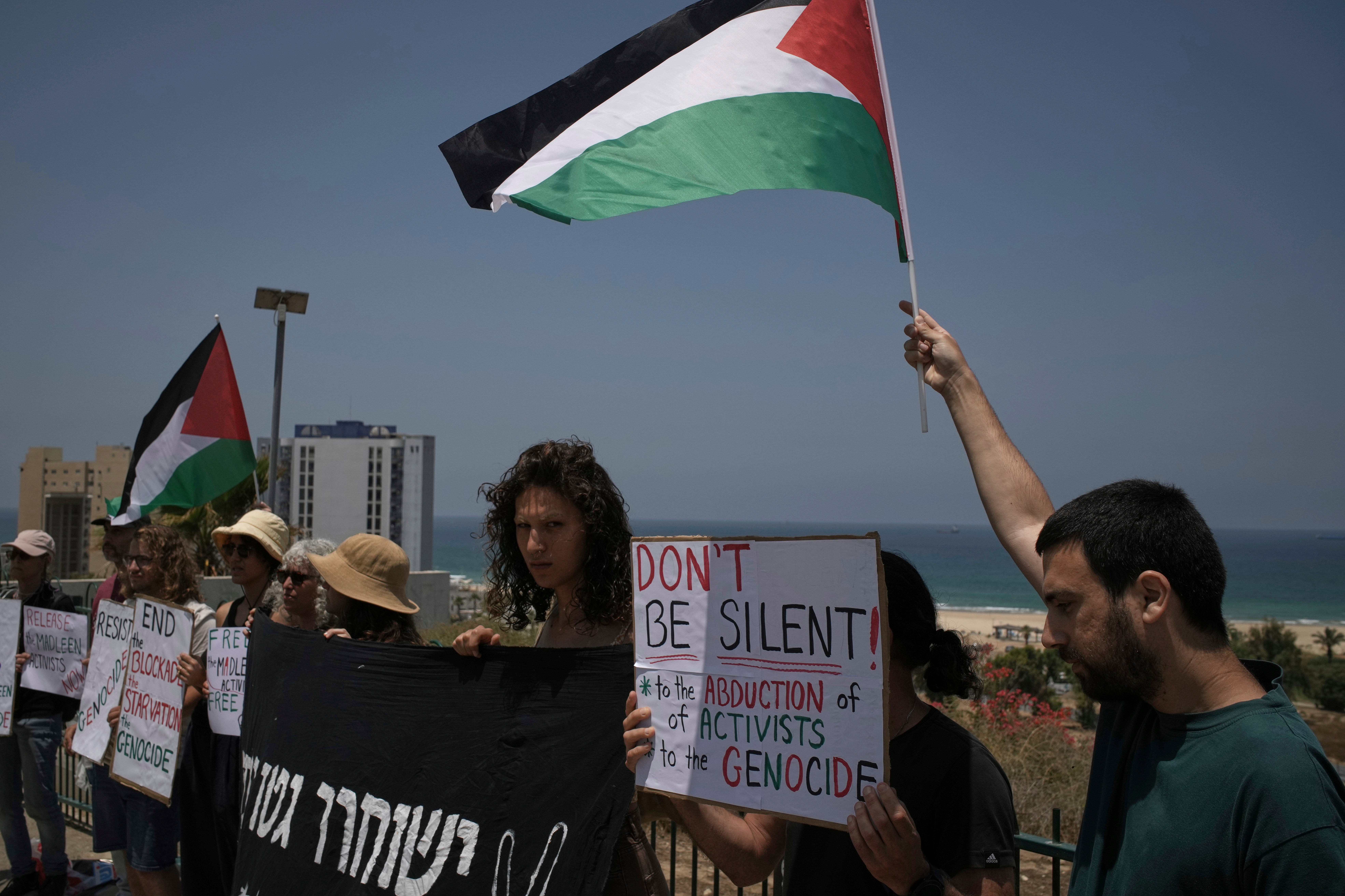 Ljudi maše palestinskom zastavom i drže znakove u prilog Greti Thunberg i ostalim aktivistima koji su pokušali pružiti pomoć Gazi prije nego što je njihov brod zaplijenjen u blizini luke Ashdod