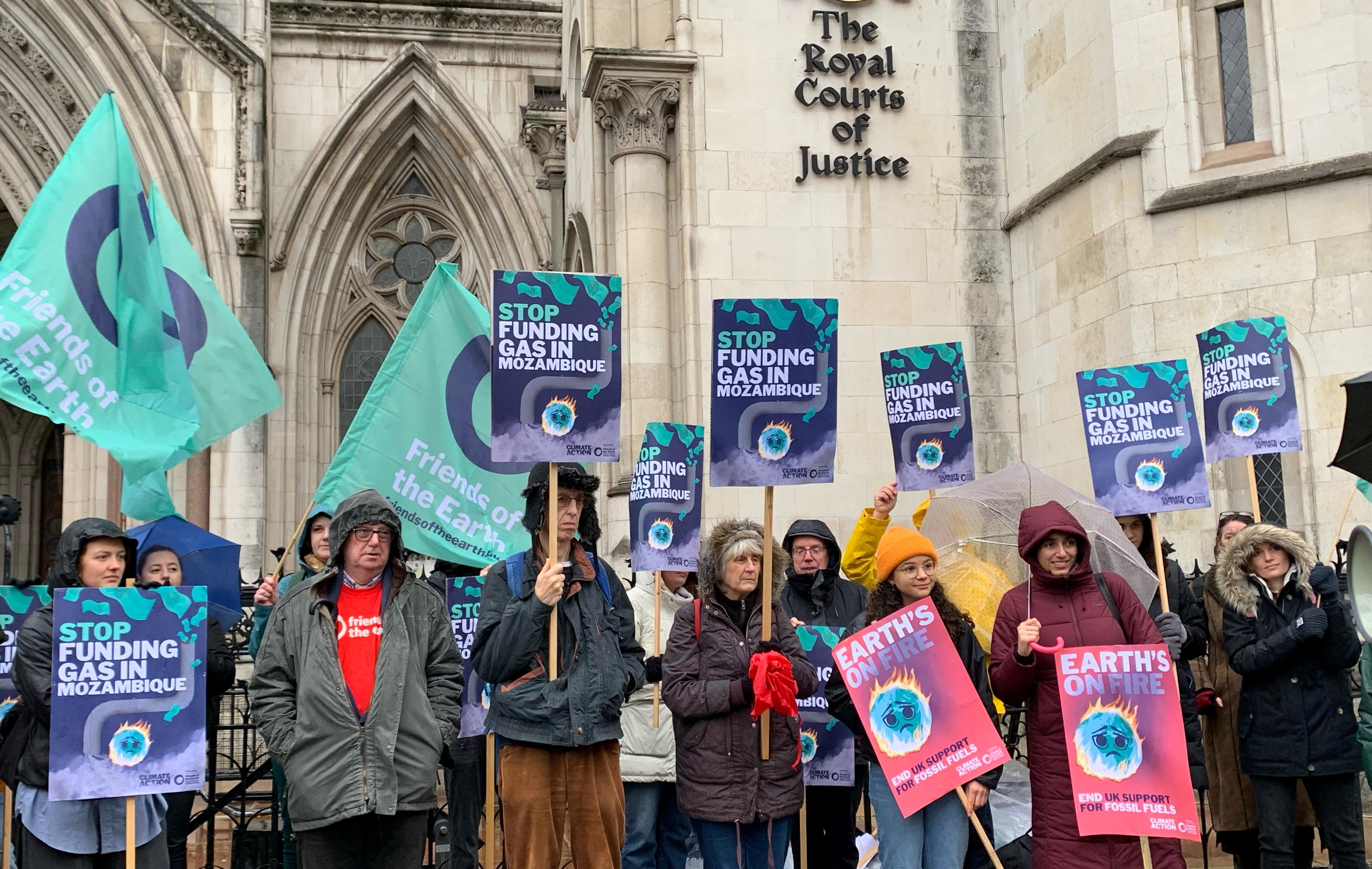 Activists supporting Friends of the Earth outside the Royal Courts of Justice in London, during a protest over the development of a liquefied natural gas project in Mozambique in 2021