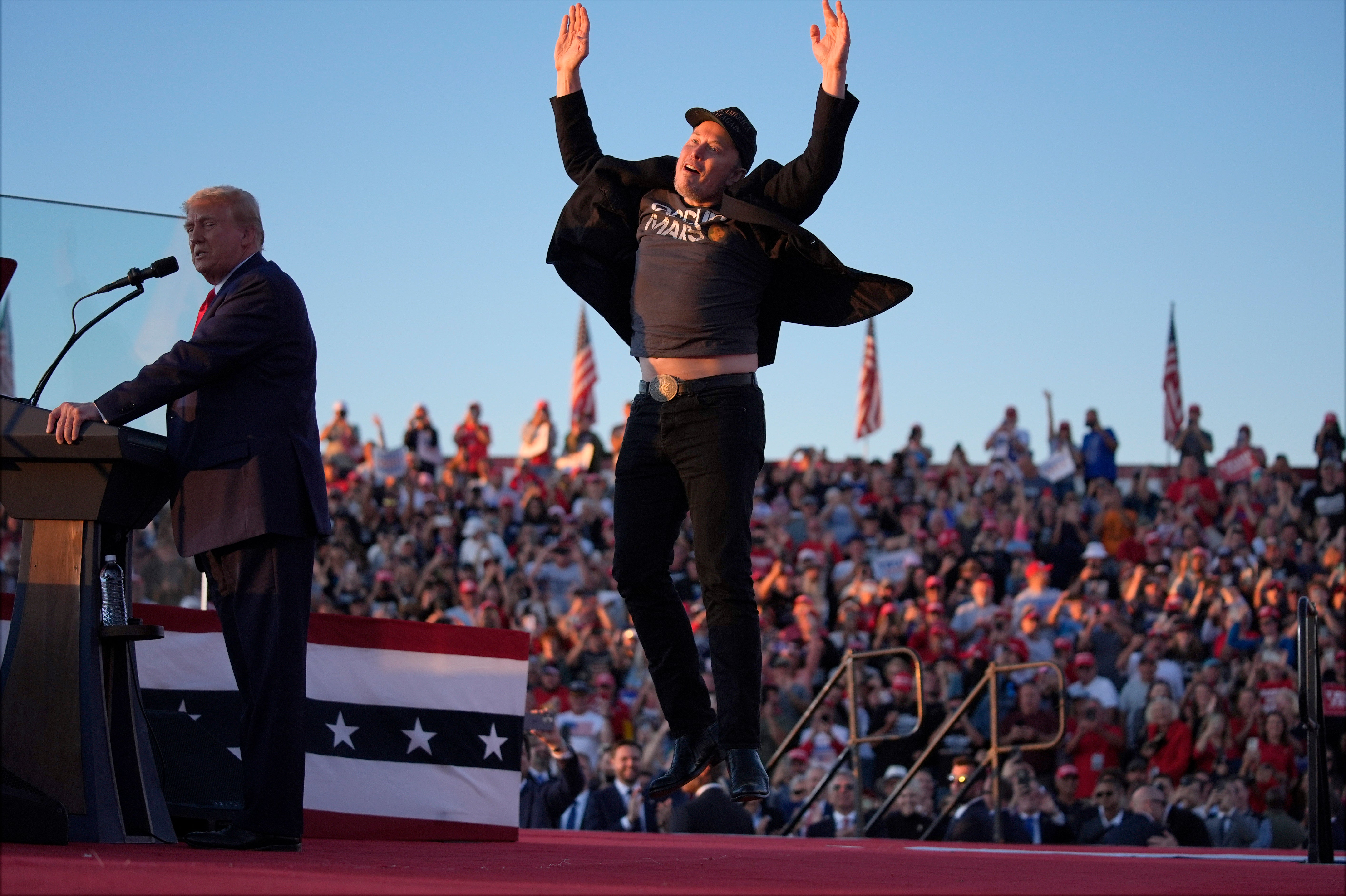Musk jumps on the stage as Trump speaks at a campaign rally in Butler, Pennsylvania