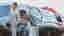 Matt Damon and Christina Bale stand beside a car