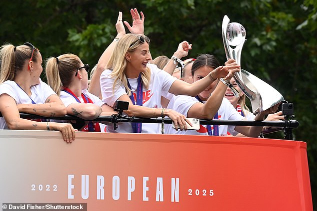 Ekstatični igrači Engleske na vrhu autobusa dok su se kotrljali niz tržni centar s trofejem