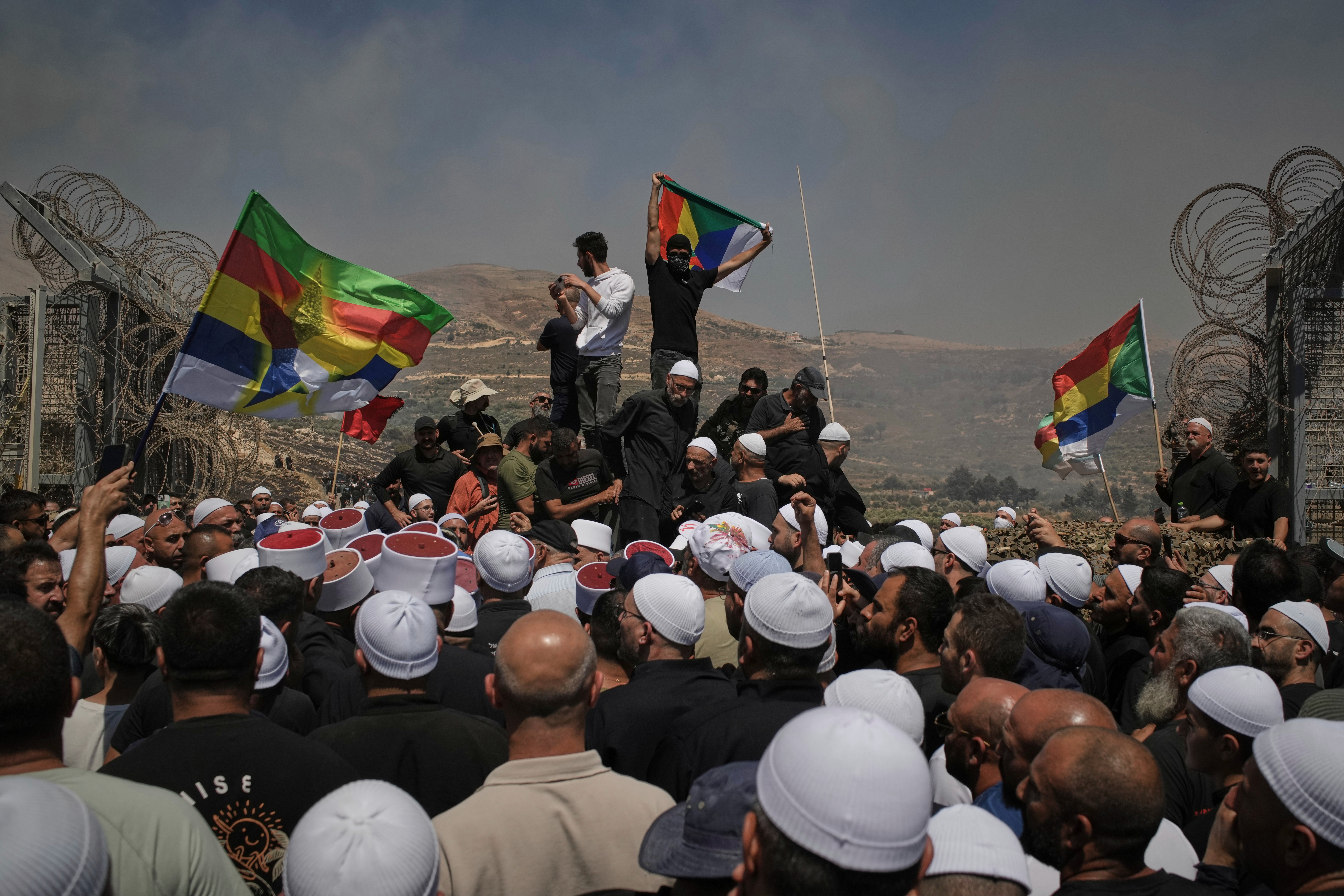 Druze iz Sirije i Izraela prosvjeduju na izraelsko-sirijskoj granici, u Majdalnim šamama u izraelskim kontroliranim Golanskim visinama, u srijedu, 16. srpnja 2025., usred sukoba sirijskih vladinih snaga i oružja Druze u južnom sirijskom gradu Sweida. (AP Photo/Leo Correa)