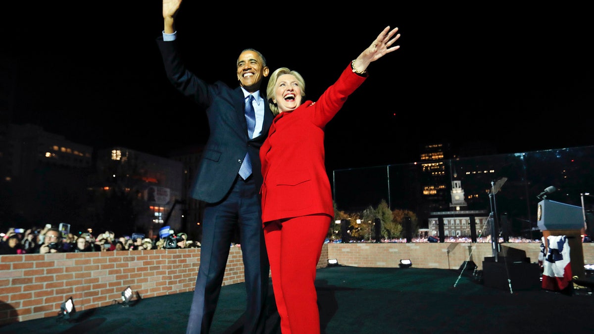 President Barack Obama waves on stage with Democratic presidential candidate Hillary Clinton during a rally at Independence Hall in Philadelphia, Monday, Nov. 7, 2016. (AP Photo/Pablo Martinez Monsivais)
