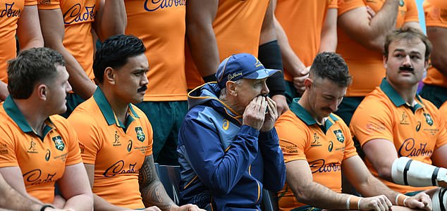 The entire Wallabies team including coach Joe Schmidt (centre left)  wear stick on moustache's for retiring player Nic White (centre right) during an Australian Wallabies media opportunity at Accor Stadium, in Sydney, Friday, August 1, 2025. (AAP Image/Dean Lewins) NO ARCHIVING