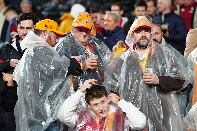 Fans shelter from the rain before the Qatar Airways Lions Tour match at Accor Stadium in Sydney, Australia. Picture date: Saturday August 2, 2025. PA Photo. Photo credit should read: David Davies/PA Wire.RESTRICTIONS: Use subject to restrictions. Editorial use only, no commercial use without prior consent from rights holder.