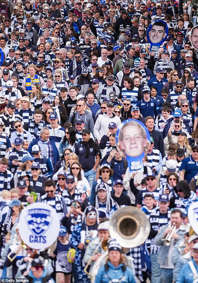 MELBOURNE, AUSTRALIA - SEPTEMBER 27: Geelong Cats fans march in Birrarung Marr towards The MCG ahead of the AFL Grand Final match between Geelong Cats and Brisbane Lions on September 27, 2025 in Melbourne, Australia. (Photo by Asanka Ratnayake/Getty Images)