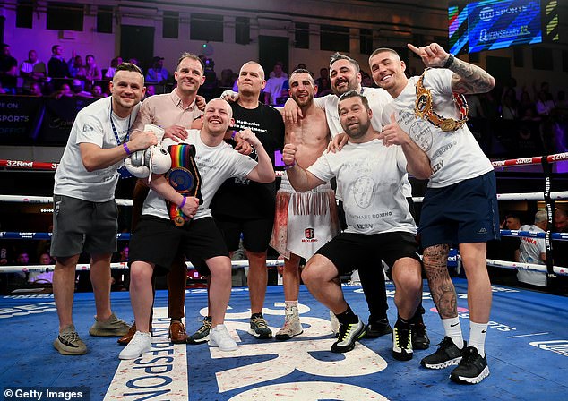 Collins with his coaching team as he celebrates victory after defeating Francesco Grandelli