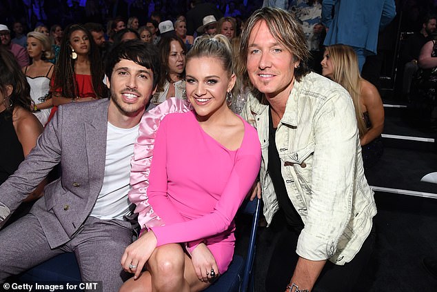 Plavuša rođena u Tennesseeju ranije je bila u braku s australskom seoskom zvijezdom Morgan Evans (lijevo). Bivši par prikazan je na CMT Music Awards 2019 s Keithom