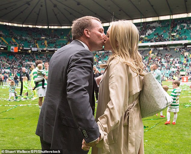 Rodgers is pictured kissing Searle after Celtic were presented with the league trophy in 2017