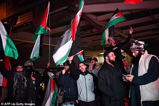 Demonstrators wave Palestinian flags in Birmingham ahead of the match. There were fears of mob violence in the lead-up to the game