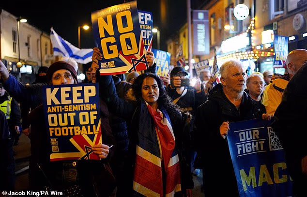 Pro Israel supporters are led to Villa Park waving banners protesting the ban against Maccabi Tel Aviv