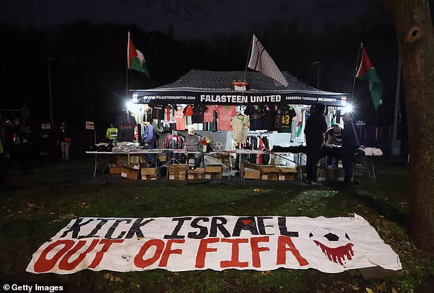 A banner laid out on a green near to Villa Park, suggesting Israel should be banned by FIFA, football's governing body