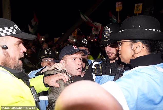 Officers pictured separating a man from the rest of the crowd as things boiled over in Birmingham