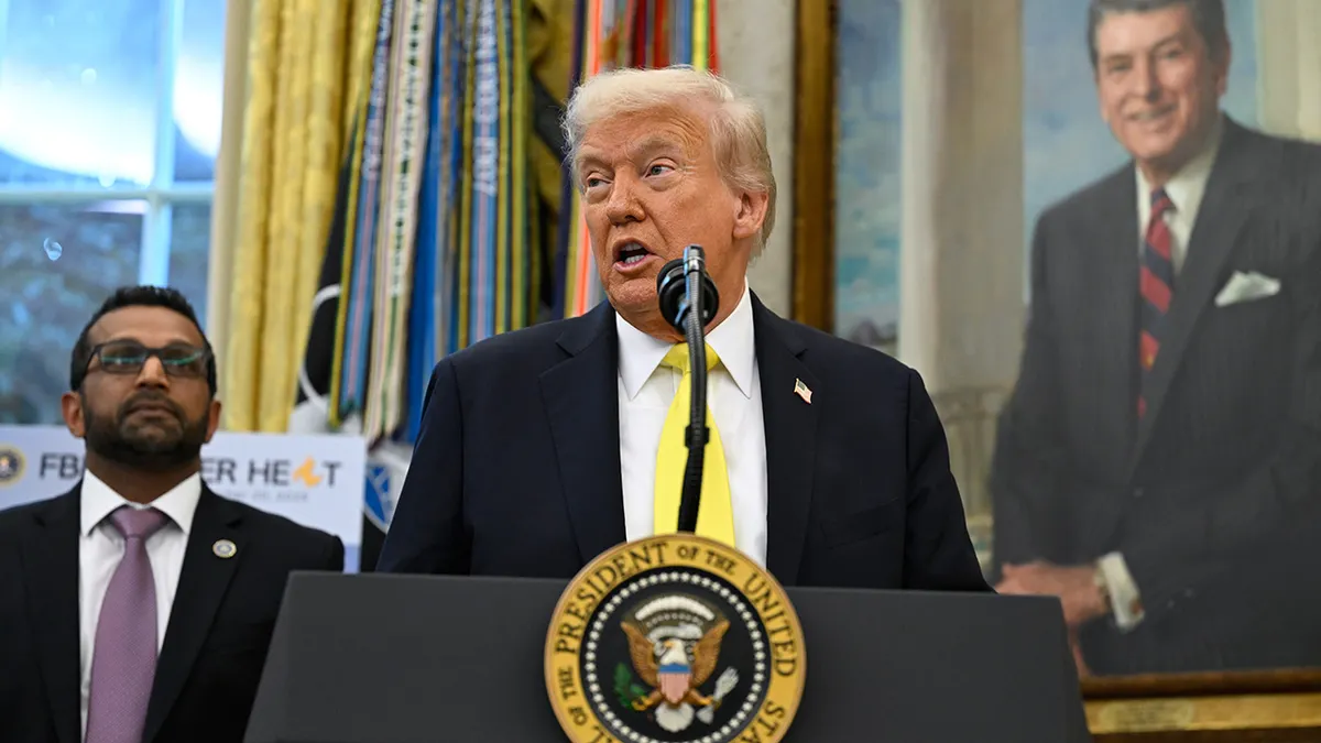 President Donald Trump speaks as FBI Director Kash Patel looks on in the Oval Office, Wednesday, Oct. 15, 2025.