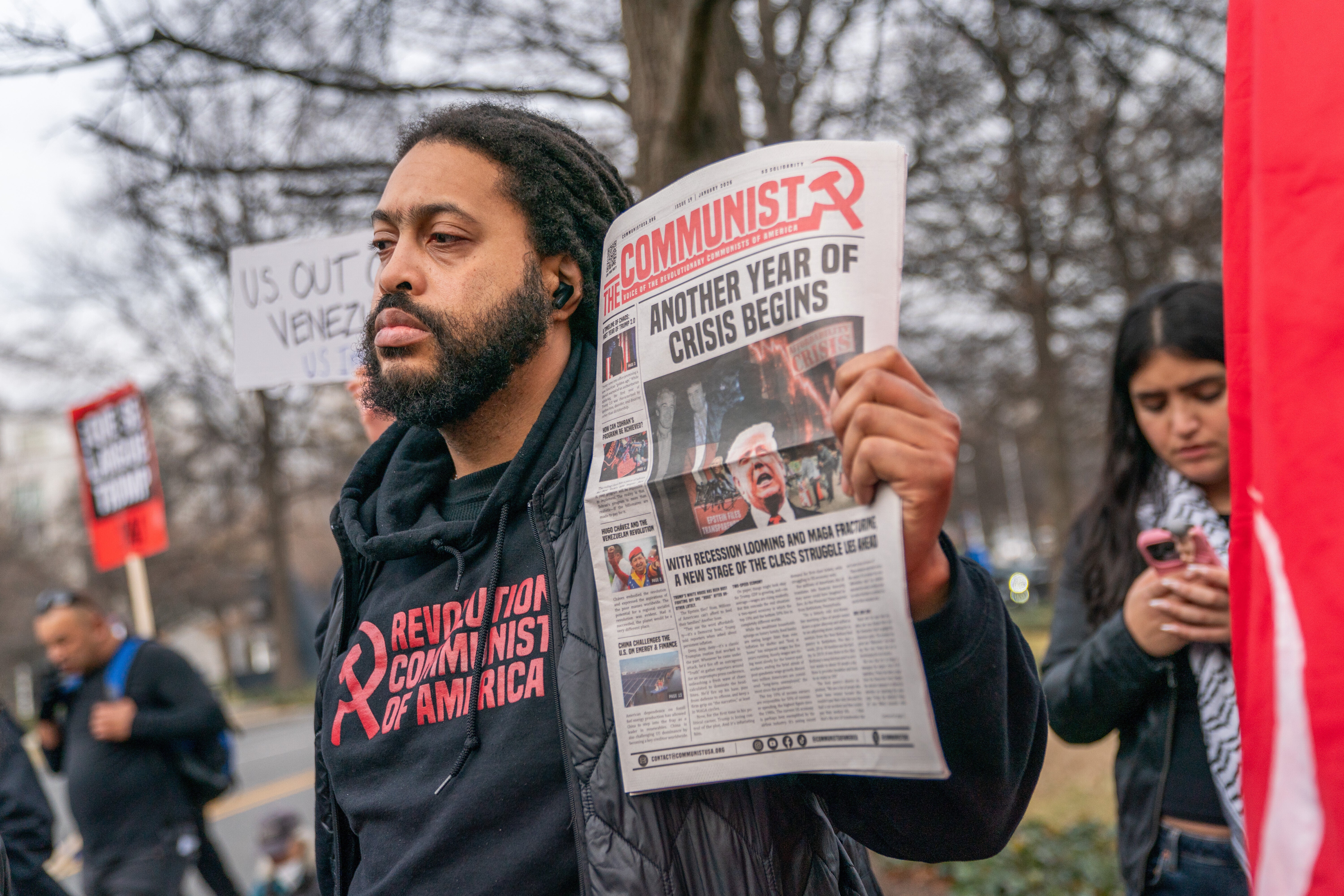 A participant holds a protest sign at a rally outside of the John F. Kennedy Center for the Performing Arts demanding end to U.S. intervention in Venezuela