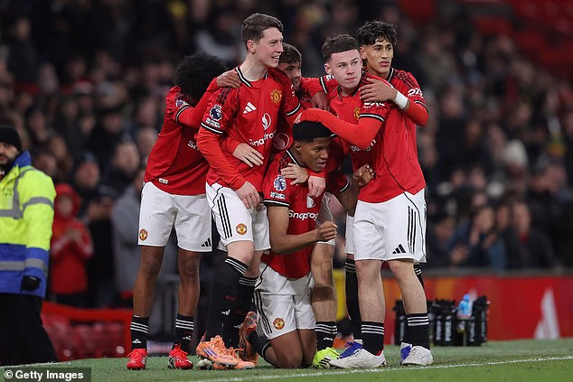 United's Chido Obi celebrates with team-mates after scoring during the FA Youth Cup fourth round match against Derby in January. He is benefitting from playing across two youth teams